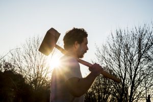 man with hammer preparing to smash marketing barriers